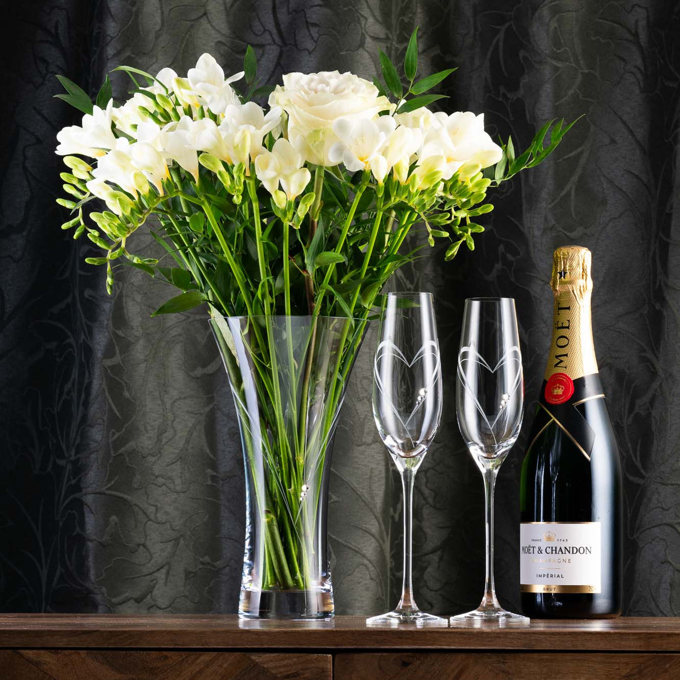 Champagne flutes and vase adorned with Swarovski crystals